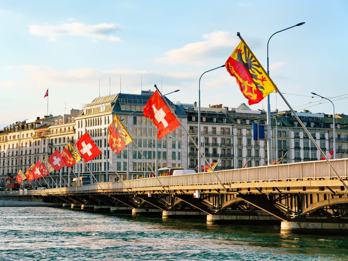 Geneva,Lake,And,Mont-blanc,Bridge,With,Flags,,Geneva,City,Center